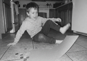 Mother and young son sitting together on a park bench outdoors