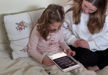 Tablet on a blanket showing the Legends app with a Billie story screen